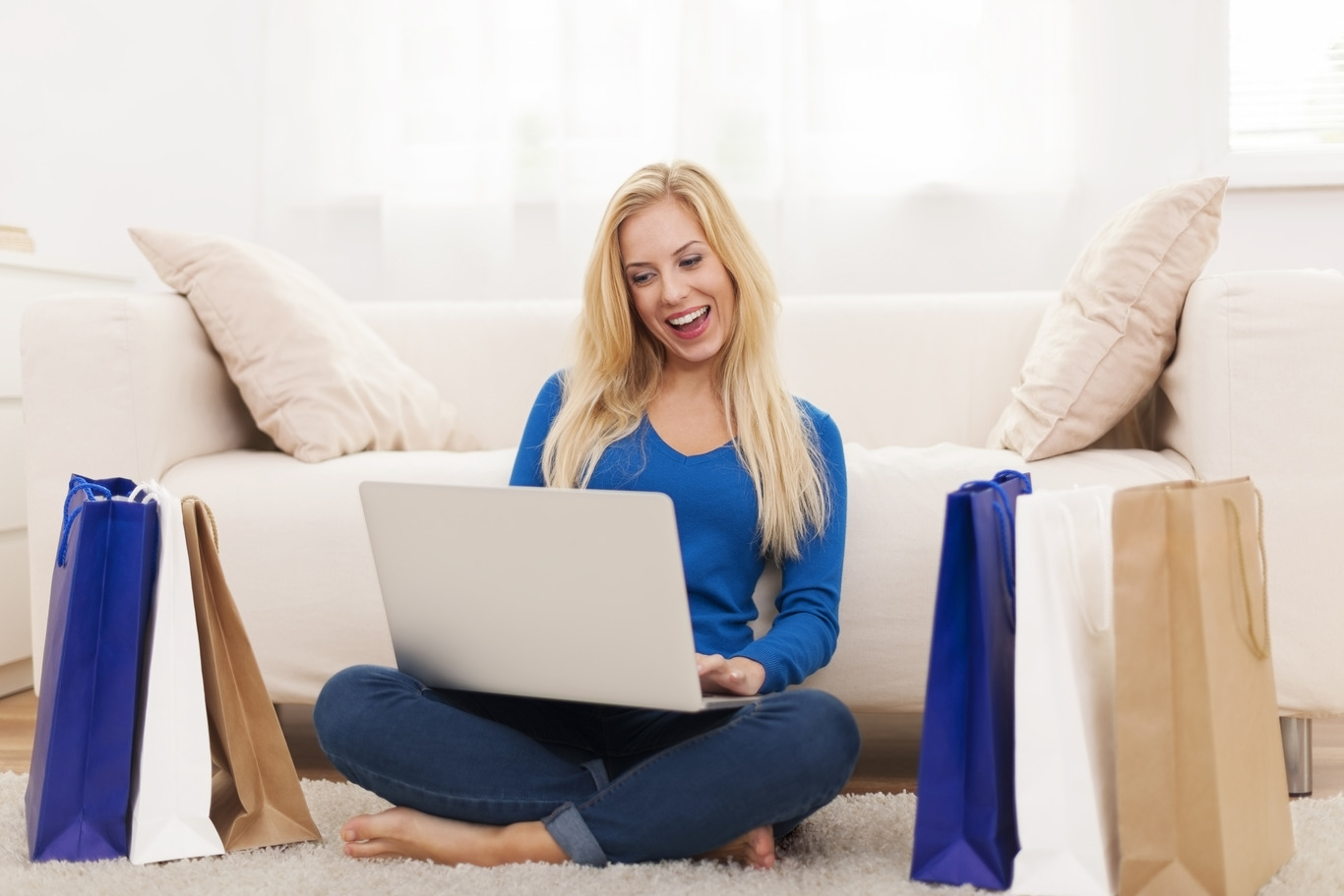 Happy shopper browsing deals on laptop